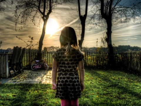 a little girl standing in the garden