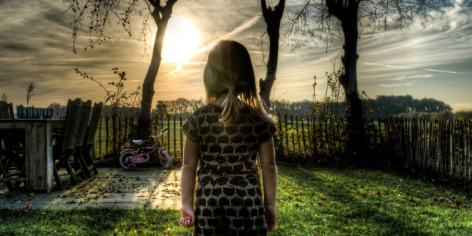 a little girl standing in the garden